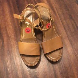 Brown leather wedge sandals.